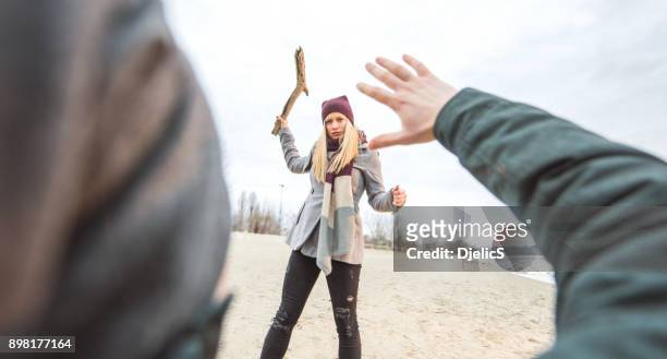 young woman attacking a stranger on the ground. - stick plant part stock pictures, royalty-free photos & images