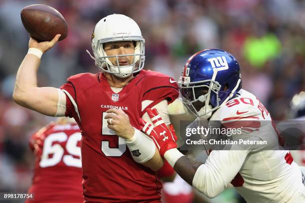 Quarterback Drew Stanton of the Arizona Cardinals throws a pass under pressure from defensive end Jason Pierre-Paul of the New York Giants during the...