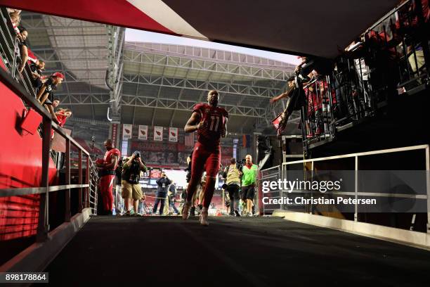 Wide receiver Larry Fitzgerald of the Arizona Cardinals runs off the field following the NFL game against the New York Giants at the University of...