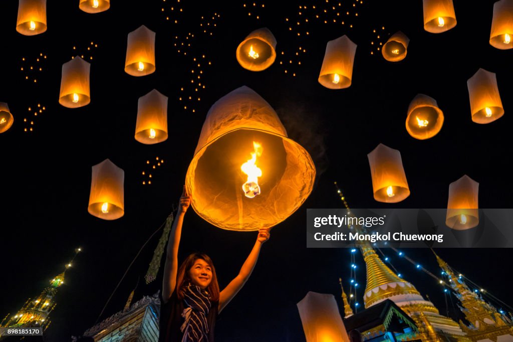 Beautiful asian women release sky lanterns to worship buddha's relics in yi peng or yee peng festival at Wat Jongklang temple - Wat Jongkham temple in Mae hong son near Chiang mai, Thailand.