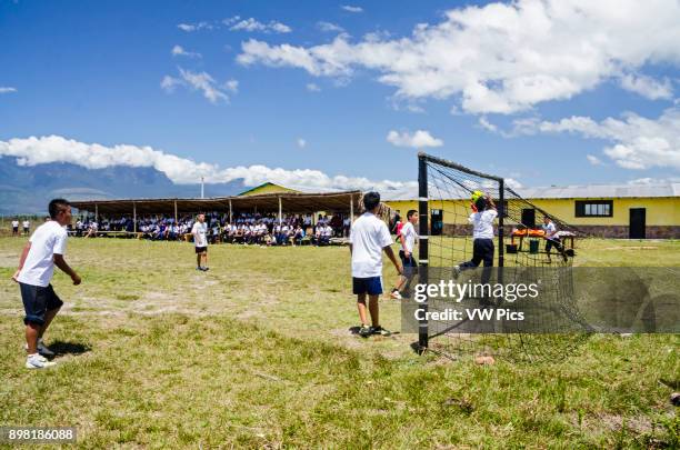 Some students from the school of Kamarata, located in the national park Canaima, Venezuela play a soccer game, in their field of sports having...