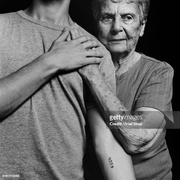 Auschwitz survivor Livia Ravek is photographed with her Grandson Daniel Philosoph on August 31, 2012 in Bnei Zion, Israel. She was tattooed with from...