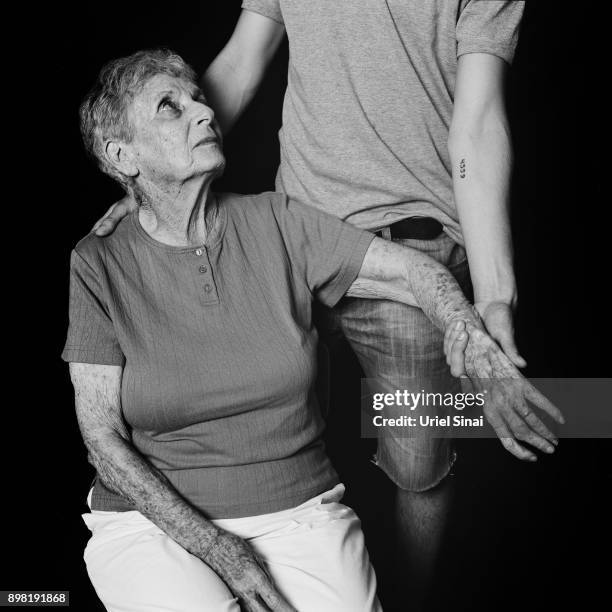 Auschwitz survivor Livia Ravek is photographed with her Grandson Daniel Philosoph on August 31, 2012 in Bnei Zion, Israel. She was tattooed with from...