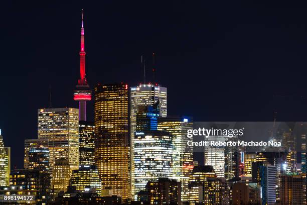 Urban skyline at night. The shot includes the CN Tower which is one of the modern world marvels and a symbol of Canada.
