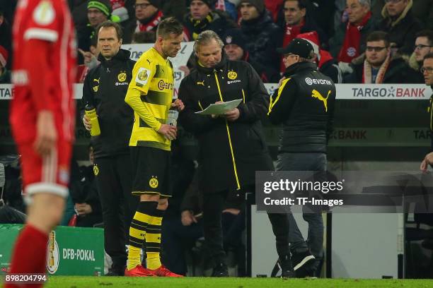 Andrey Yarmolenko of Dortmund speaks with Goalkeeper coach Wolfgang de Beer of Dortmund during the DFB Cup match between Bayern Muenchen and Borussia...