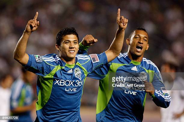 Fredy Montero of the Seattle Sounders FC celebrates his second half goal with teammate Tyrone Marshall against the Los Angeles Galaxy at the Home...