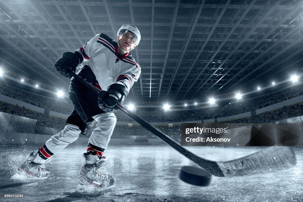 Ice hockey player on big professional ice arena