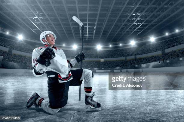 ice hockey player rejoices in victory - hockey player puck stock pictures, royalty-free photos & images