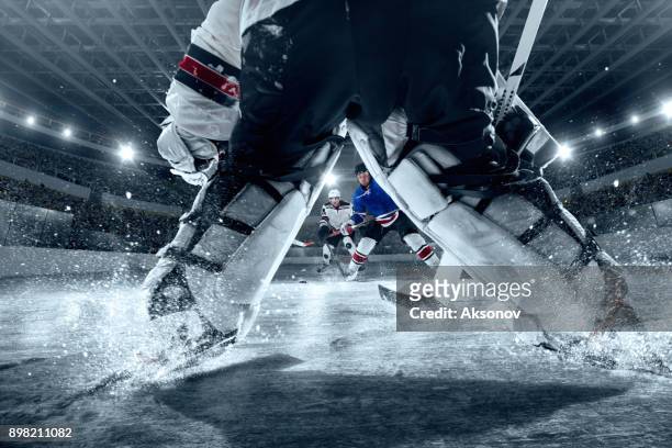 ice hockey players on big professional ice arena. view from the hockey gate - hockey stock pictures, royalty-free photos & images