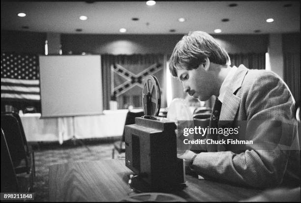 American white supremacist and Grand Wizard of the Ku Klu Klan David Duke sets up a projector for a KKK meeting in the conference room of an...