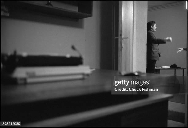 View, though an open door, of Polish trade-unionist Lech Walesa as he talks with an unidentified person in his office at Solidarity headquarters,...