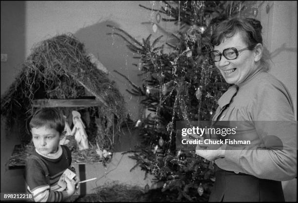 View of Polish trade unionist Anna Walentynowicz and her son, Janusz, as they stand in front of a nativity scene and Christmas tree, Gdansk, Poland,...