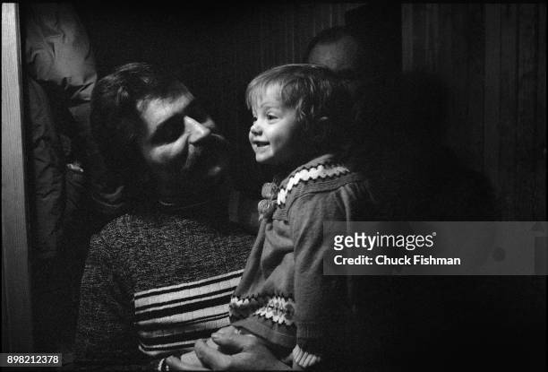 Polish trade-unionist Lech Walesa holds one of his daughters, Magdalena, before leaving for work, Gdansk, Poland, December 1980.