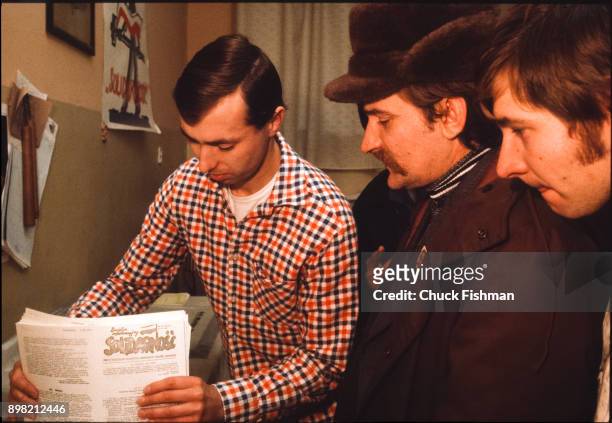 Polish trade-unionist Lech Walesa collects newsletters from a man in the printing room at Solidarity headquarters, Gdansk, Poland, December 1980.