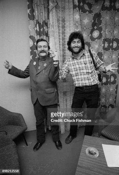 Polish trade-unionist Lech Walesa holds hands and jokes with American photographer Chuck Fishman in Walesa's office at Solidarity headquarters,...