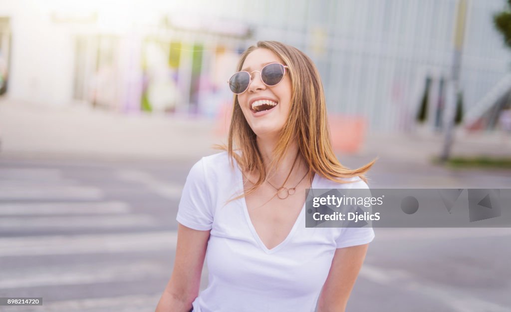 Happy young woman in the city portrait