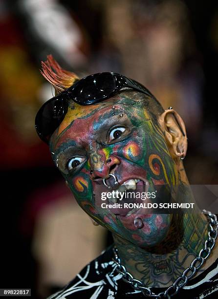 Man with a tattooed face poses for a picture on August 15 during the International Convention of Tattoo at the World Trade Center in Mexico City. AFP...