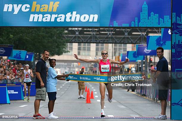 Paula Radcliffe of Great Britain crosses the finish line to win the 2009 NYC Half-Marathon in New York City on August 16, 2009 in New York, New York.