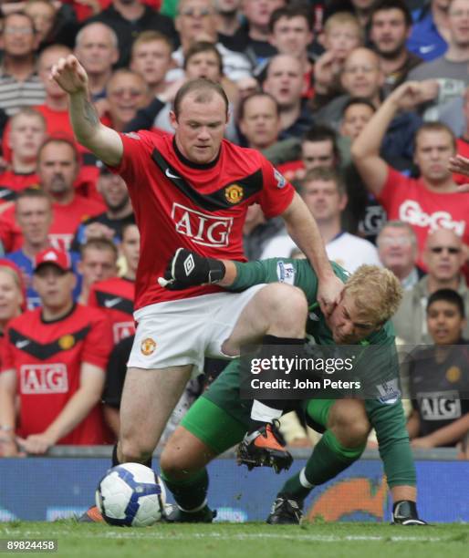 Wayne Rooney of Manchester United clashes with Joe Hart of Birmingham City during the FA Barclays Premier League match between Manchester United and...