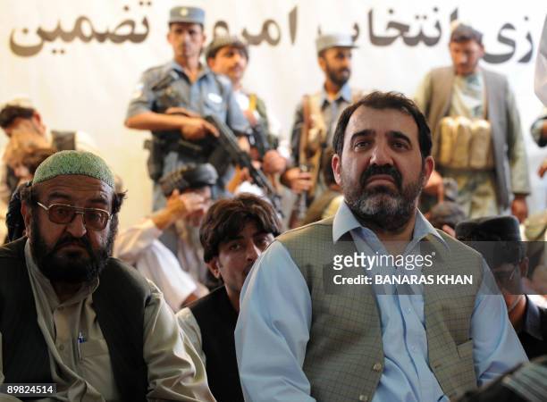Ahmed Walli, brother of Afghan President Hamid Karzai, sits along with Karzai supporters at an election gathering in Kandahar on August 16, 2009. The...