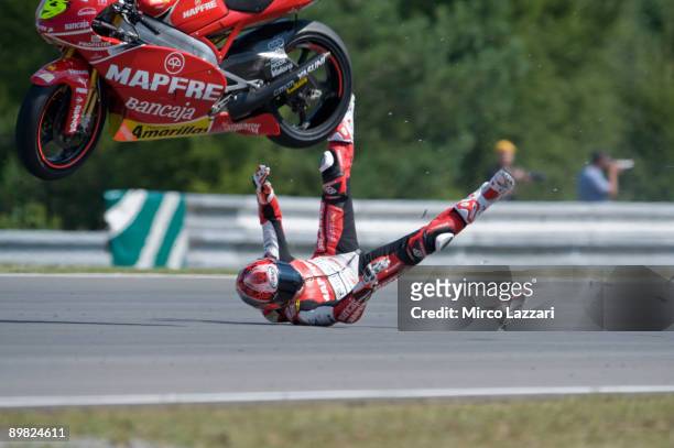 Alvaro Bautista of Spain and Mapfre Aspar Team crashes out while attempting a wheelie after finishing the 250cc race in third place in the MotoGP...
