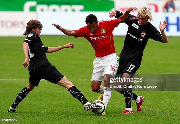 Charles of Lokomotiv Moscow battles for the ball with Milos Krasic and Georgi Schennikov of CSKA Moscow during the Russian Football League...