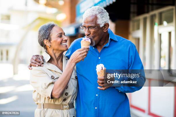 african american senior couple on the town with ice cream - senior adult eating stock pictures, royalty-free photos & images