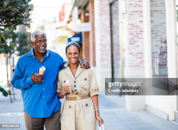 african american senior couple on the town with ice cream - older black people shopping stock pictures, royalty-free photos & images