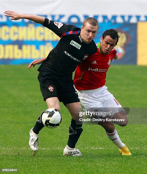 Charles of Lokomotiv Moscow battles for the ball with Pavel Mamaev of CSKA Moscow during the Russian Football League Championship match between...