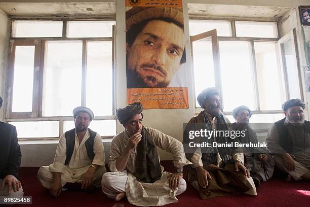 Afghan presidential candidate and former foreign minister Dr Abdullah Abdullah looks on as he sits under a poster of the late Ahmad Shah Mehsud in...