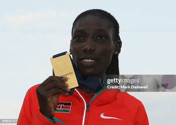 Linet Chepkwemoi Masai of Kenya receives the gold medal during the medal ceremony for the women's 10,000 Metres Final during day two of the 12th IAAF...