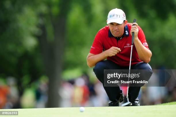 Padraig Harrington of Ireland lines up a putt on the first hole during the final round of the 91st PGA Championship at Hazeltine National Golf Club...