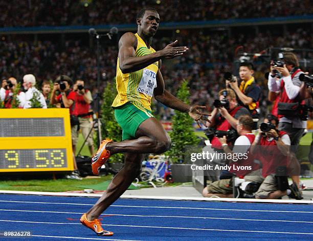 Usain Bolt of Jamaica crosses the line to win the gold medal in the men's 100 Metres Final during day two of the 12th IAAF World Athletics...