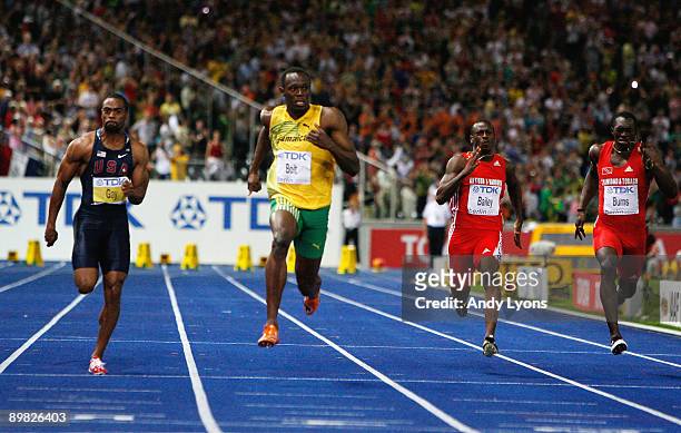 Tyson Gay of United States, Usain Bolt of Jamaica, Daniel Bailey of Antigua and Barbuda and Marc Burns of Trinidad and Tobago compete in the men's...