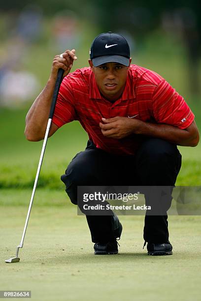 Tiger Woods lines up a putt on the second hole during the final round of the 91st PGA Championship at Hazeltine National Golf Club on August 16, 2009...