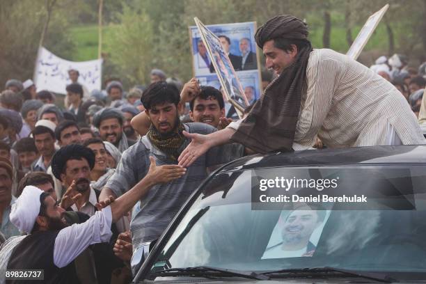 Afghan presidential candidate and former foreign minister Dr Abdullah Abdullah greets supporters during a campaign stop in his heartland province of...