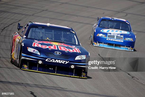 Brian Vickers, driver of the Red Bull Toyota, leads Kuret Busch, driver of the Miller Lite Dodge, during the NASCAR Sprint Cup Series CARFAX 400 at...