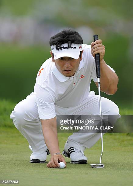 Yong-Eun Yang of South Korea lines up a putt during the final round of the 91st PGA Championship on August 16, 2009 at the Hazeltine National Golf...