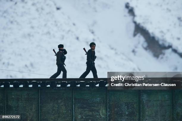 two north korean soldiers walking with weapons - remote guarding stock pictures, royalty-free photos & images