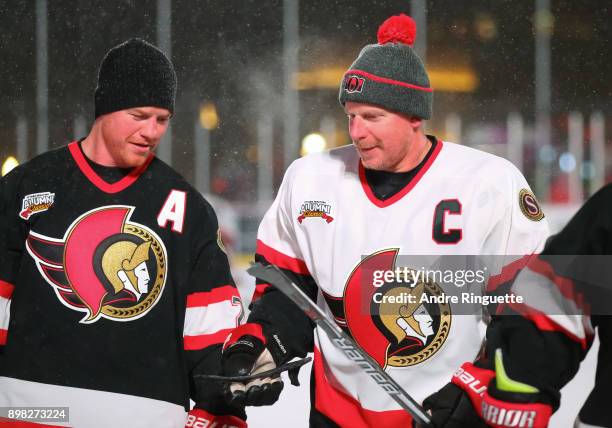 Ottawa Senators alumni Daniel Alfredsson shows a broken stick to Chris Neil during warmup during the 2017 Scotiabank NHL100 Classic Ottawa Senators...