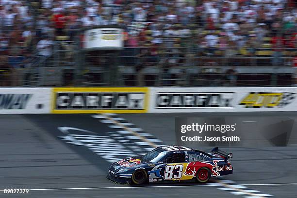 Brian Vickers, driver of the Red Bull Toyota, crosses the start/finish line to take the checkered flag and win at the NASCAR Sprint Cup Series CARFAX...