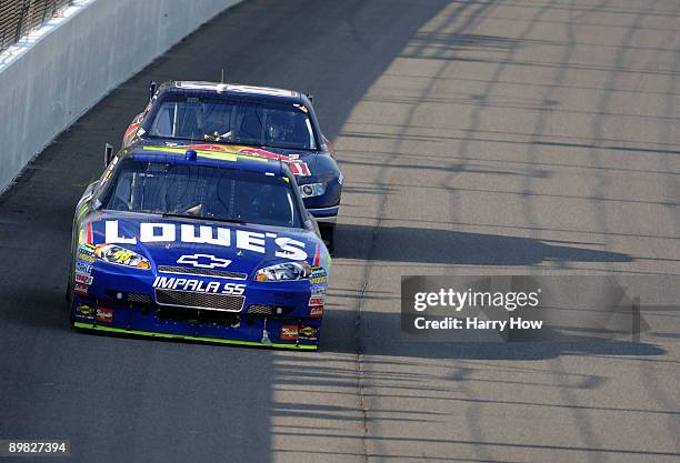 Jimmie Johnson, driver of the Lowe's Chevrolet, leads Brian Vickers, driver of the Red Bull Toyota, during the NASCAR Sprint Cup Series CARFAX 400 at...