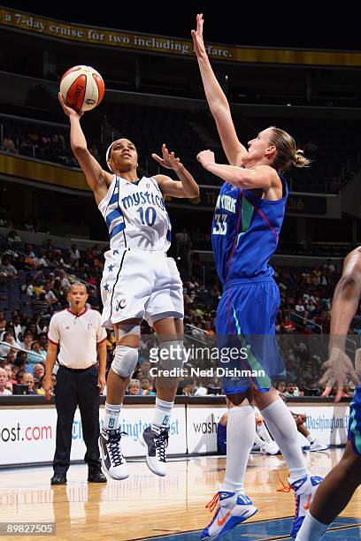 Lindsey Harding of the Washington Mystics shoots against Catherine Kraayeveld of the New York Liberty at the Verizon Center on August 16, 2009 in...