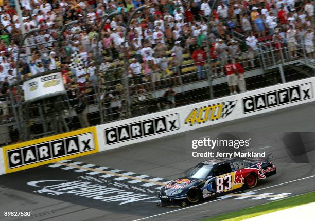 Brian Vickers, driver of the Red Bull Toyota, crosses the start/finish line to take the checkered flag and win at the NASCAR Sprint Cup Series CARFAX...