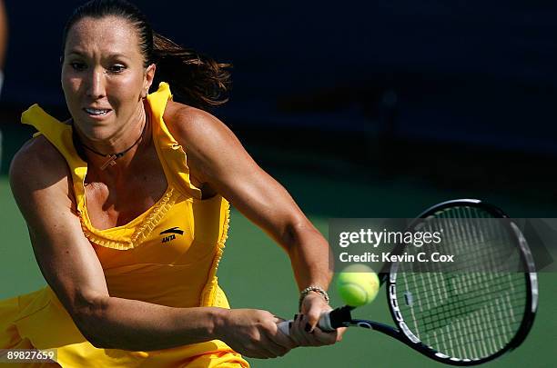 Jelena Jankovic of Serbia returns a shot to Dinara Safina of Russia in the finals of the Western & Southern Financial Group Women's Open on August...