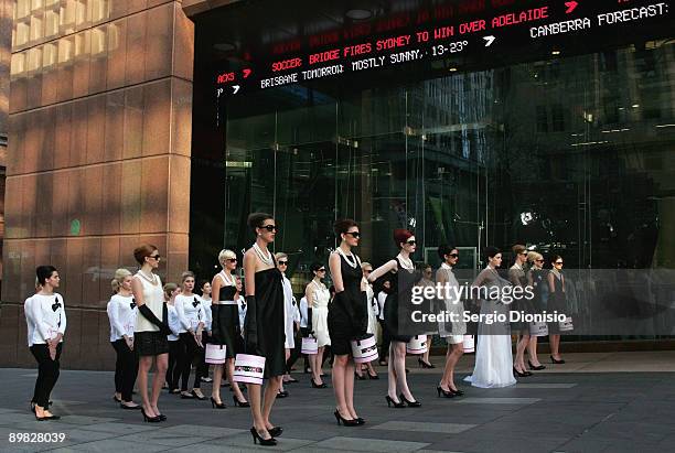 Models made-up to look like screen star Audrey Hepburn, pose in front of channel seven studio's to celebrate Hepburn's 80th birthday this year and...