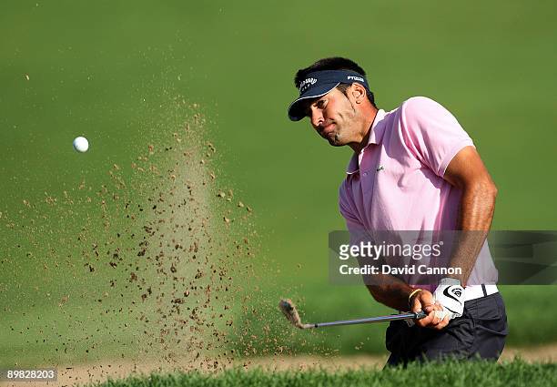 Alvaro Quiros of Spain plays from a bunker on the 18th hole during the final round of the 91st PGA Championship at Hazeltine National Golf Club on...