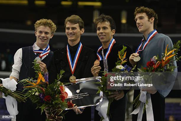 Timothy Goebel, silver, Todd Eldredge, gold, Michael Weiss, bronze and Matthew Savoie, pewter pose with their medals on the podium after the men's...