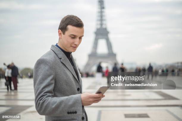businessman using smart phone in paris, eiffel tower - esplanade du trocadero stock pictures, royalty-free photos & images