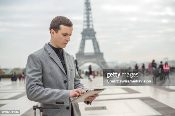 young business ma in paris using digital tablet, france - esplanade du trocadero stock pictures, royalty-free photos & images